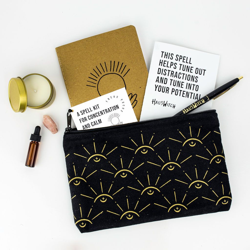 The full Focus Pocus Spell Kit featuring the back of the reusable pouch, which has a gold sunburst pattern.