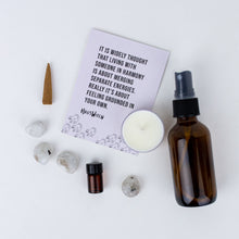 Load image into Gallery viewer, Contents of Co-Habitate Spell Kit. Instruction card, 4 crystals, incense cone, tealight candle, amber potion bottle, and amber spray bottle of rosewater.
