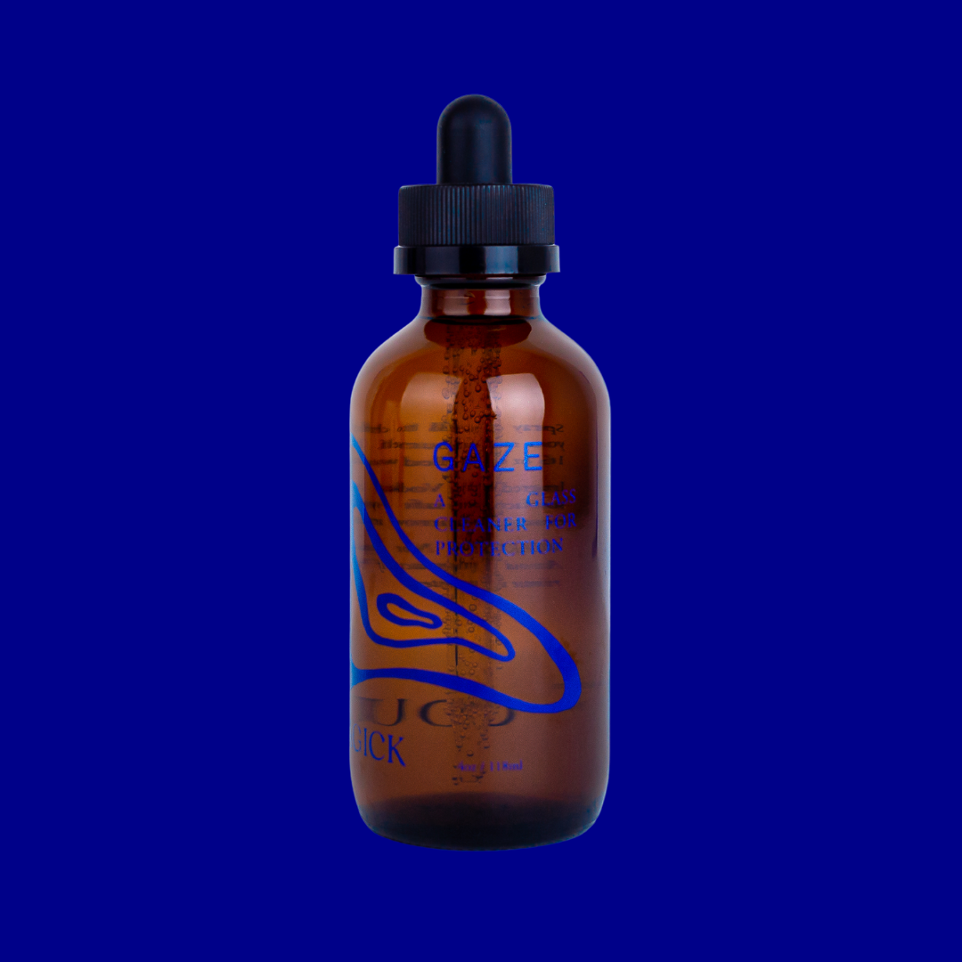 Gaze: A glass cleaner for protection, in an amber glass bottle intentionally adorned with minimalist navy blue swirls. 4 oz/118 mL.