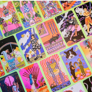Examples of cards from Queer Tarot: An Inclusive Deck & Guidebook. All are illustrated in bright, groovy colors and feature characters based on real models representing a full range of gender and sexual identities, races, ethnicities, and abilities. Cards pictured include The Lovers, The Hierophant, The Emperor, Queen of Swords, 5 of Swords, 4 of Swords, Knight of Swords, Page of Swords, 9 of Wands, 10 of Wands, Ace of Cups, and 2 of Cups. 