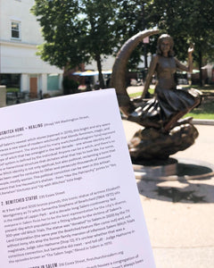 Salem's famous bronze statue of a witch in a dress perched sideways on a crescent moon. In the foreground is a page from Walking the Witch Trials: A DIY Tour of Salem History. Blurbs of text describe HausWitch Home + Healing at 144 Washington Street and the pictured Bewitched Statue at 235 Essex Street. 